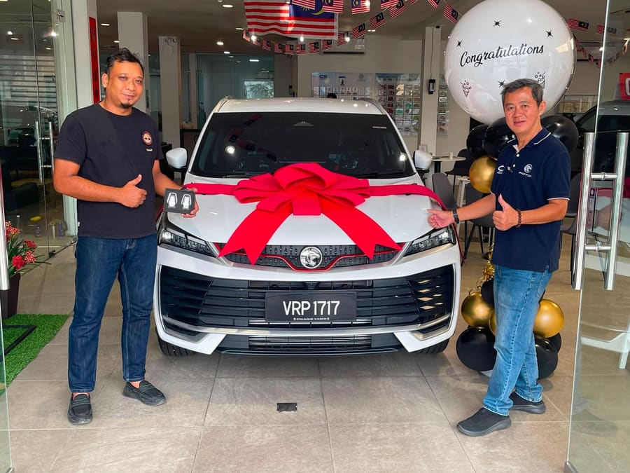 A customer collecting their new Proton