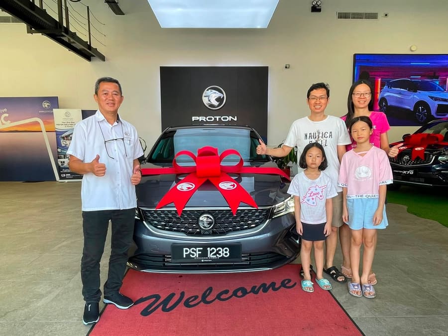 A customer collecting their new Proton