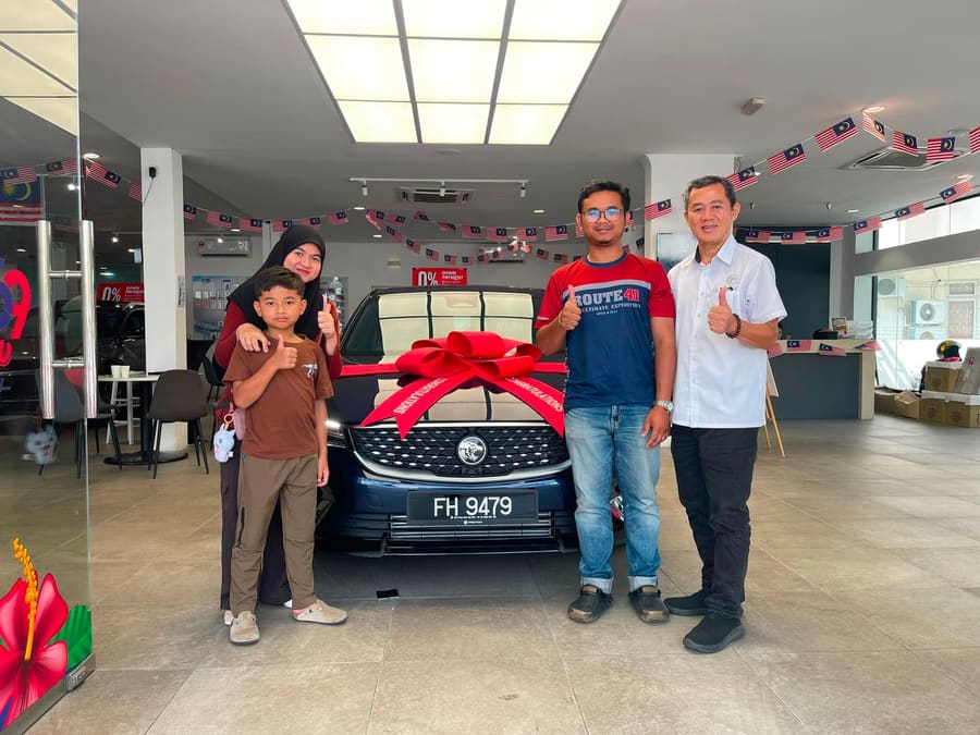 A customer collecting their new Proton
