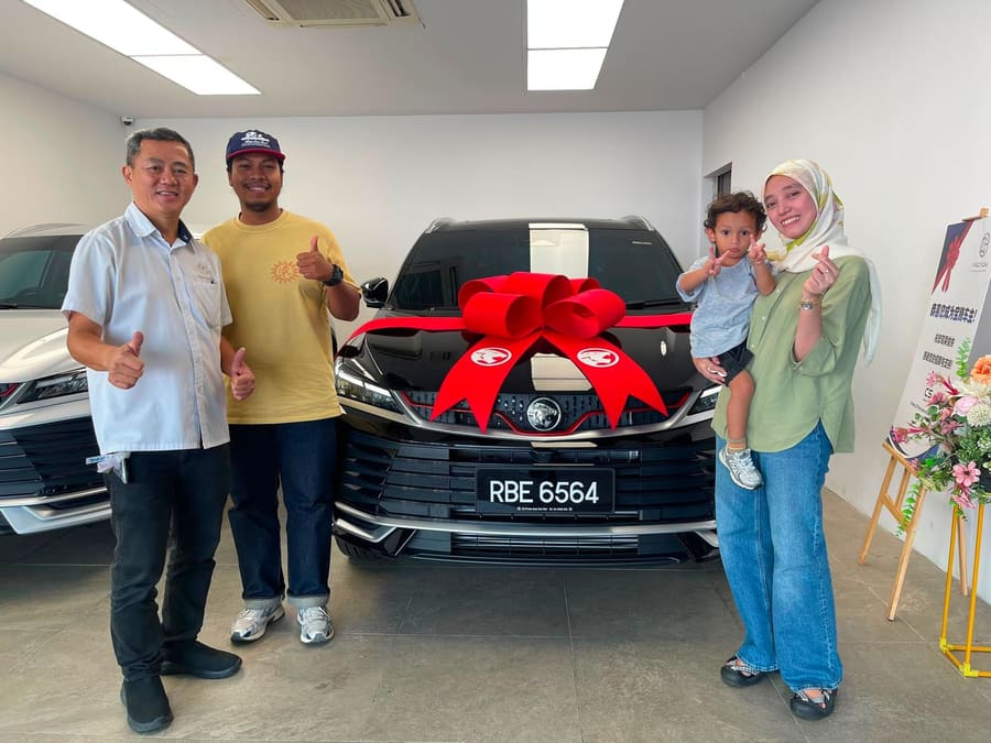 A customer collecting their new Proton