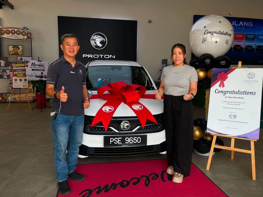 A customer collecting their new Proton