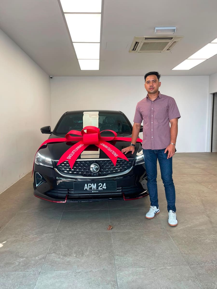 A customer collecting their new Proton
