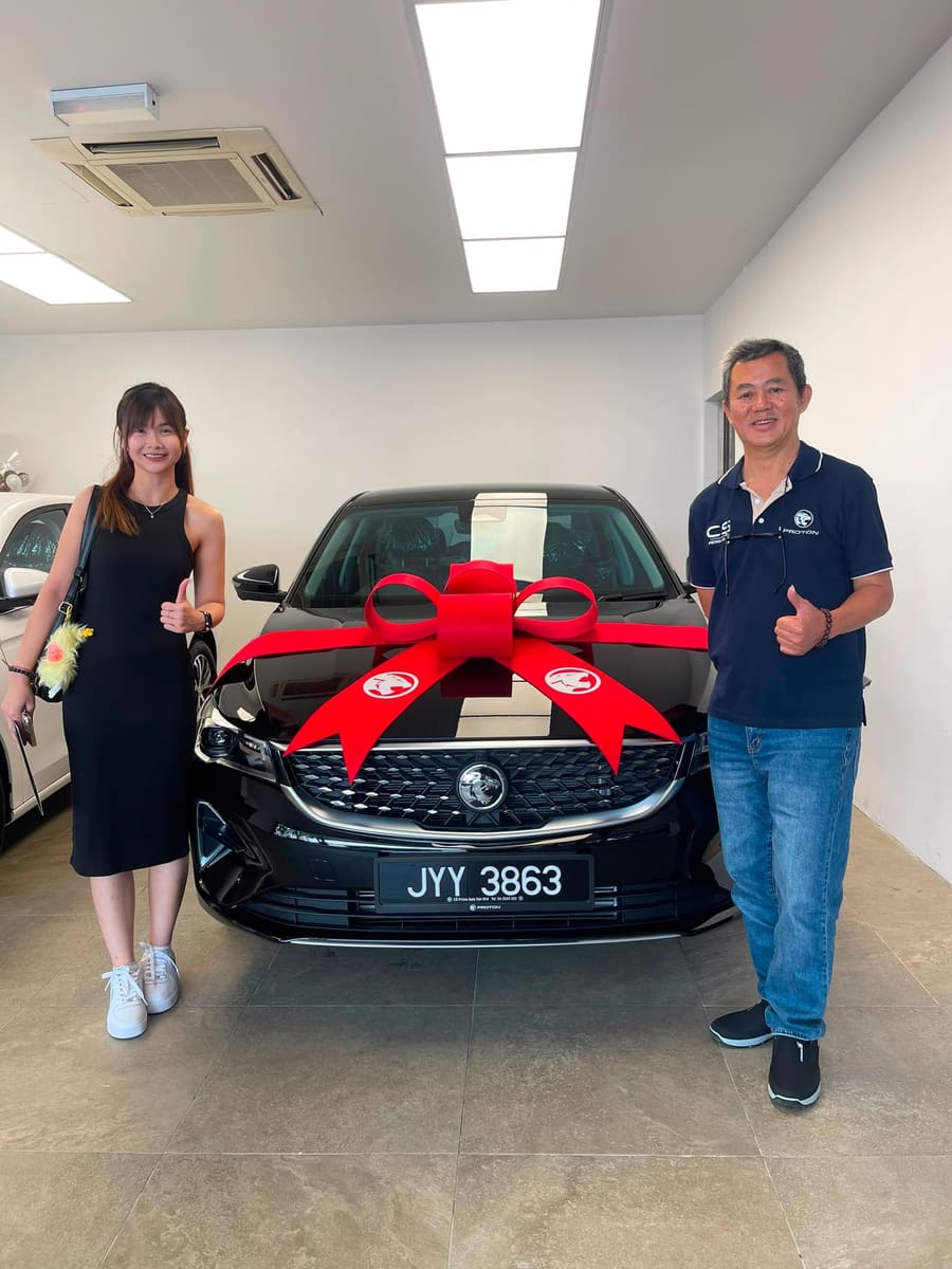 A customer collecting their new Proton