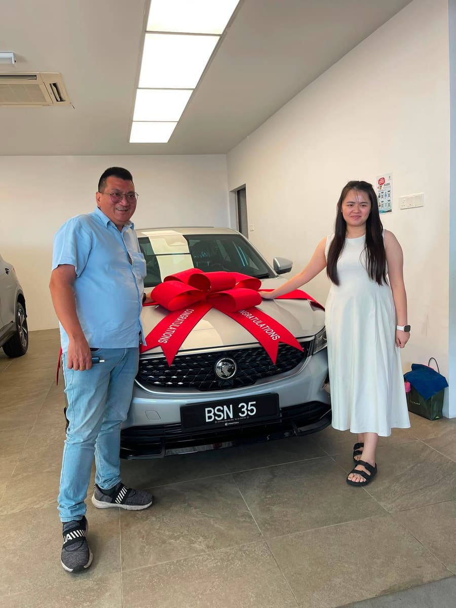 A customer collecting their new Proton