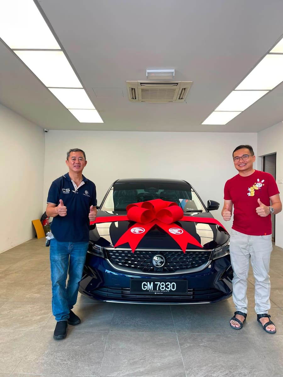 A customer collecting their new Proton