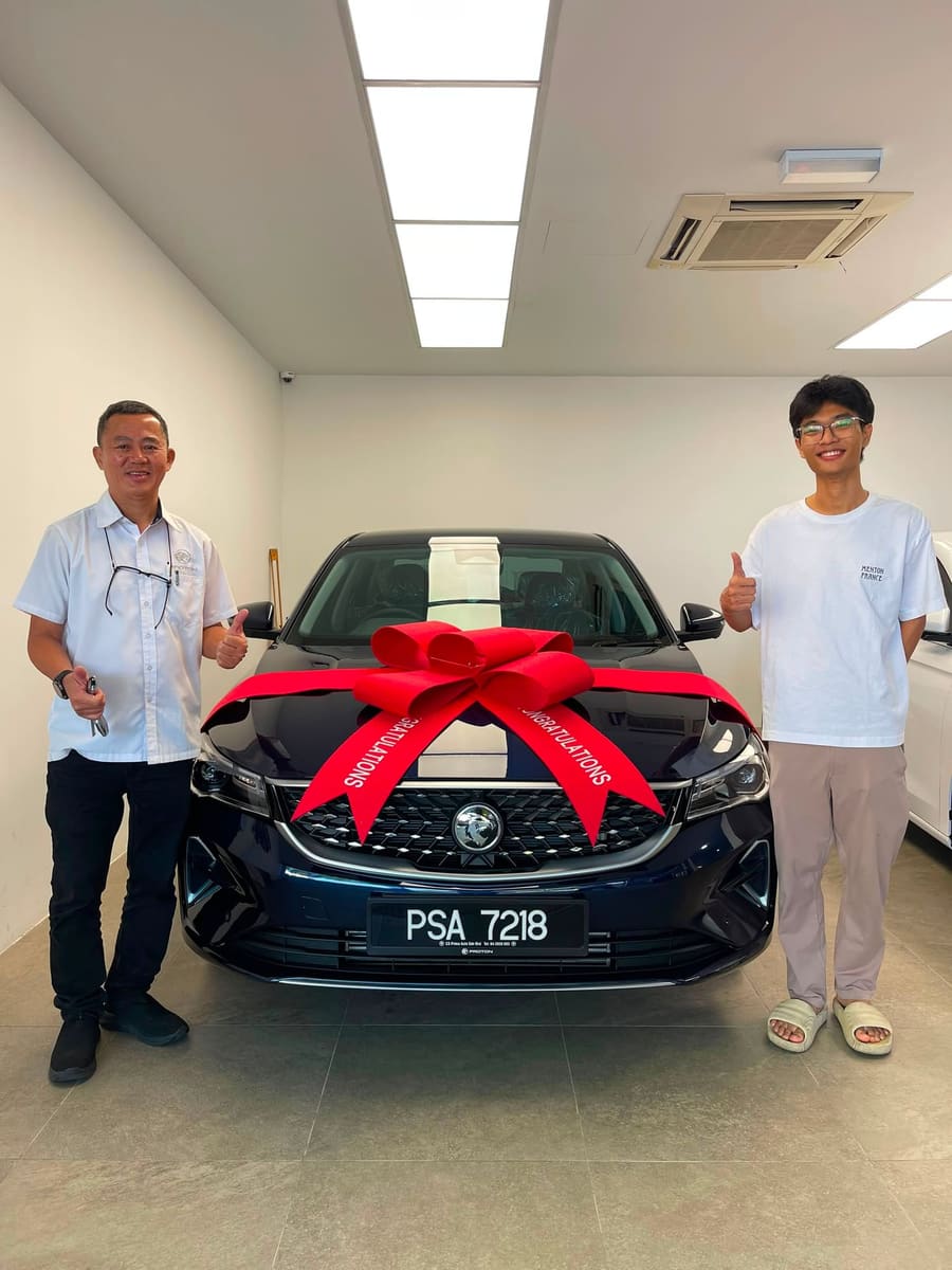 A customer collecting their new Proton
