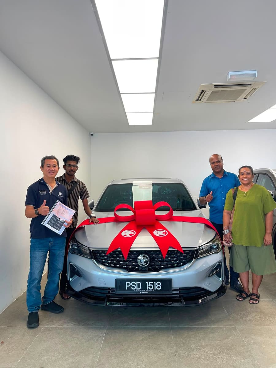 A customer collecting their new Proton